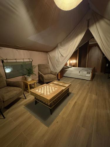a room with a tent with a bed and a table at Glamping Lake Escape in Virpazar