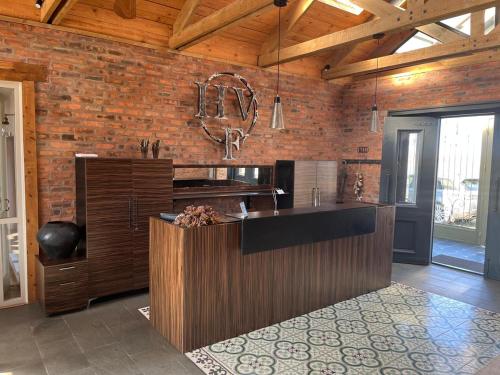 a kitchen with a counter and a brick wall at Highveldt Farm, Nottingham Road in Fort Nottingham