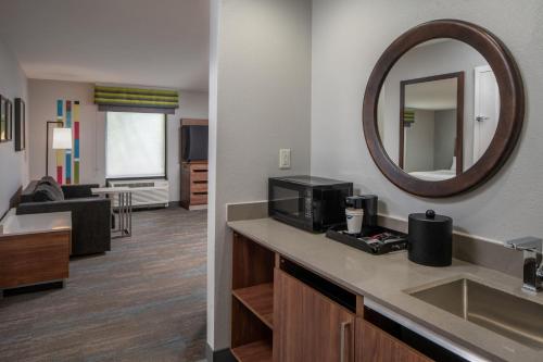 a hotel room with a sink and a mirror at Hampton Inn Enterprise in Enterprise