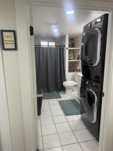 a bathroom with a washer and dryer in a room at Anthony's Home in Spokane