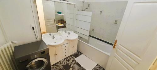a bathroom with a sink and a washing machine at Le Silodort - 7 pers - wifi - cour in Vatan