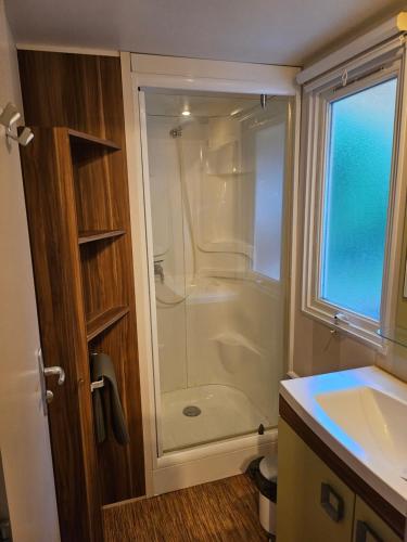 a bathroom with a shower and a sink at camping des 7 fonts in Agde