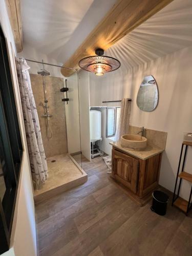a bathroom with a tub and a sink and a shower at Atelier Provençal in La Celle-sous-Gouzon