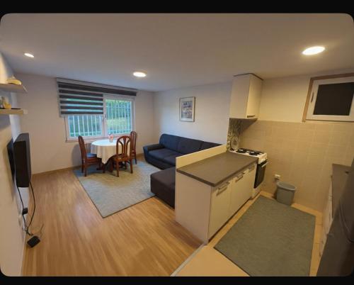 a living room with a blue couch and a table at Close to SCC Luxury apartment in Sarajevo in Sarajevo