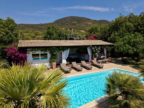 a villa with a swimming pool and a house at Villa Niloan Olbia in Olbia