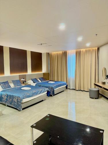 a hotel room with two beds and a table at Skyport Hotel in Manila