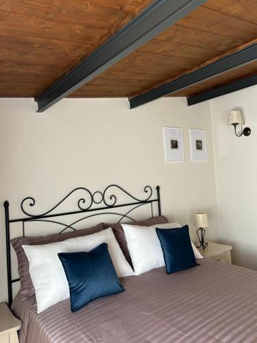 a bedroom with a bed with blue and white pillows at PIAZZADUOMO b&b Stilo in Stilo