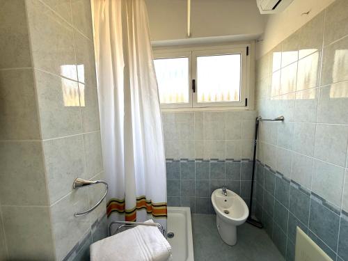 a bathroom with a toilet and a sink at Casa Liver Pieve in Tremosine Sul Garda