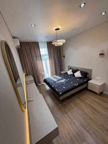 a bedroom with a bed in a room at Tamerlane Premium Apartment in Samarkand