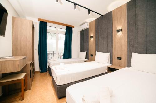 a hotel room with two beds and a window at Hotel Dajti in Ulcinj