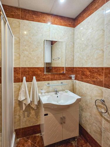 a bathroom with a sink and a mirror at Marina and Panorama Apartments in Sveti Vlas
