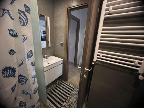 a bathroom with a toilet and a sink and a door at Luxuary pool appartement in La Marsa
