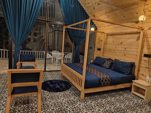 a bedroom with a bed and a chair in a room at The jungle tales in Bhīm Tāl