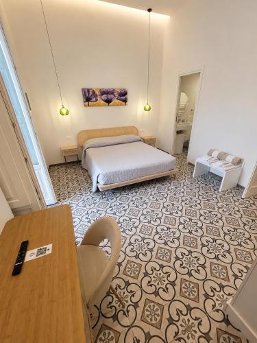 a bedroom with a bed and a table in a room at Il Pumo in Locorotondo