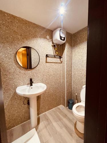 a bathroom with a sink and a toilet at Eminoky Apartment in Lagos