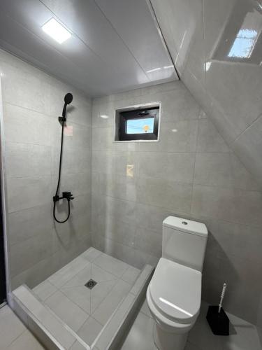 a small bathroom with a toilet and a shower at Cappadociagarden in Kutaisi