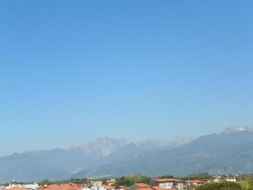 a view of a city with mountains in the background at Hotel La Vela in Lido di Camaiore