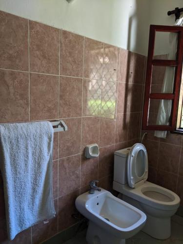 a bathroom with a toilet and a sink at Nelion Villas in Mambrui