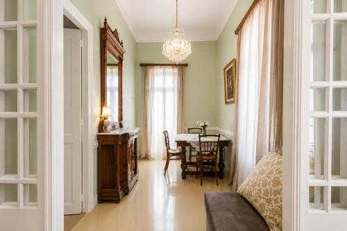 a living room with a table and a dining room at Neoclassical Mansion in Andros Town by Explore Andros in Andros