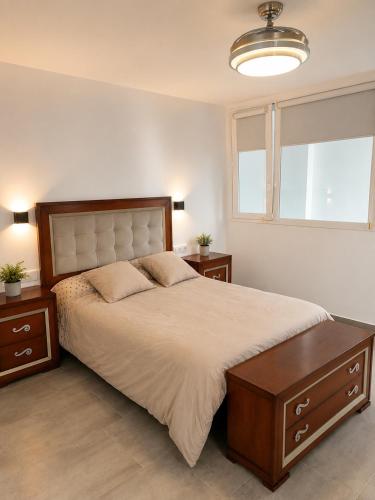 a bedroom with a large bed and two night stands at Pozo, 22 in Fuente Palmera