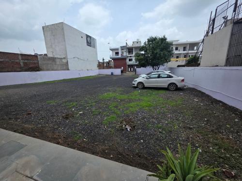a car parked in a parking lot next to a building at Hotel MNP in Jabalpur