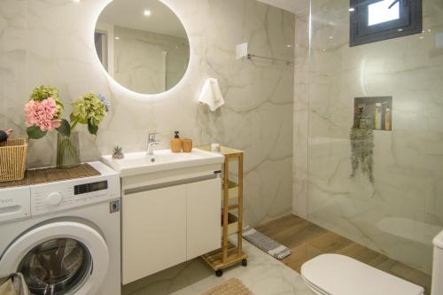 a bathroom with a washing machine and a sink at Grimihome 2 in Filiatra