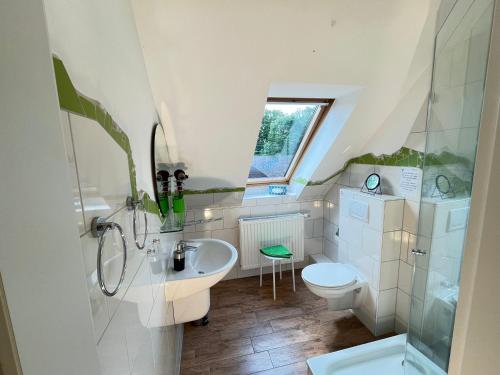 a white bathroom with a sink and a toilet at Schloms Hof in Waffensen