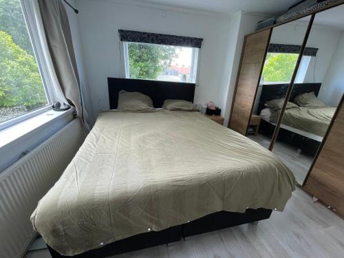 a bedroom with a large bed and a mirror at SB villa house in Vlissingen