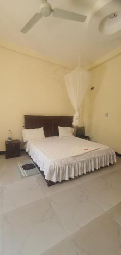 a bedroom with a large bed with a ceiling at Grace Land Hotel - Awash in Āwash