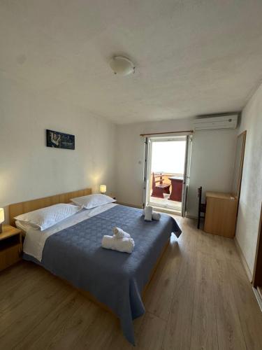 a bedroom with a large bed with towels on it at Apartments Alać in Drasnice