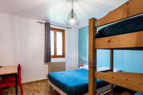 a bedroom with a bunk bed and a desk at Le Charmagit in La Roche-sur-Foron