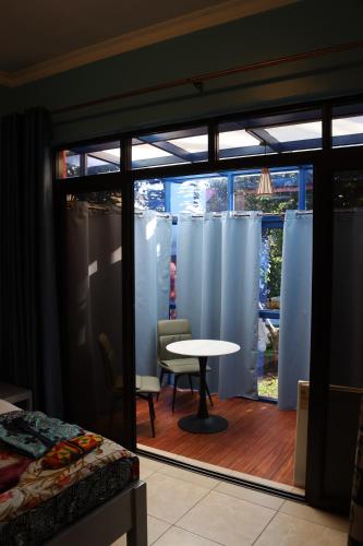 a room with a room with a table and a window at Umusambi B&B in Kigali