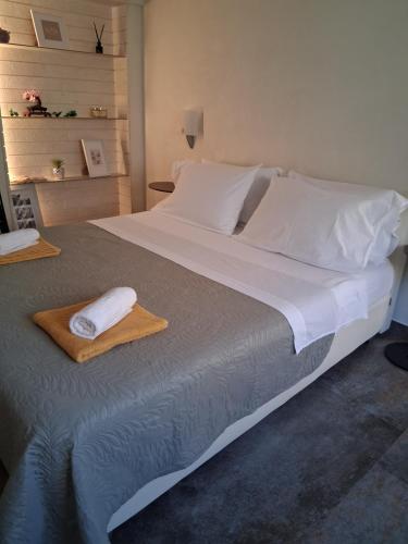 a large white bed with two towels on it at Apartman Golden Stone in Ivanica