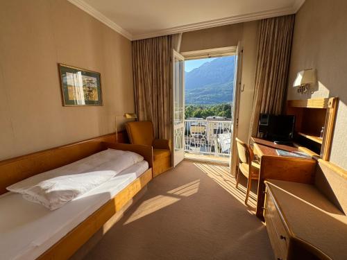 a hotel room with a bed and a window at Das Alpina in Bad Reichenhall
