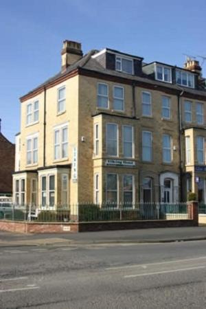 a large brick building on the side of a street at Viking Guest House in Bridlington