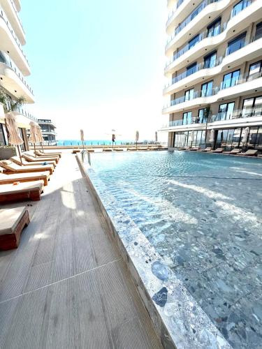a swimming pool in front of a large building at Rezidenca Onda in Lezhë