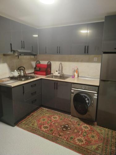 a kitchen with a sink and a washing machine at Istisu in Müqtǝdir
