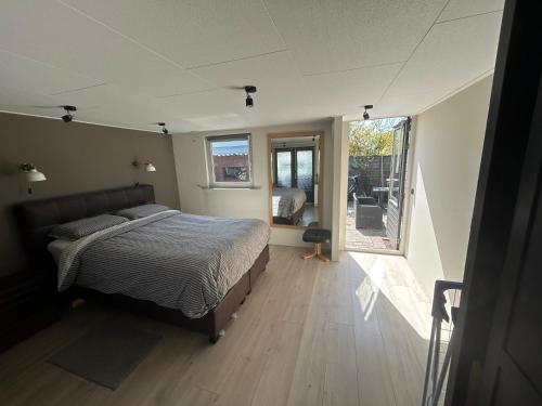 a bedroom with a bed and a large window at Casa bosrust anloo in Anloo