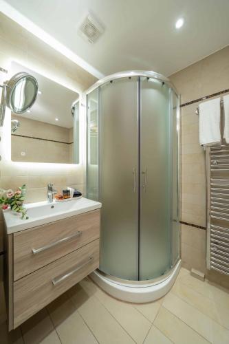 a bathroom with a shower and a sink at Argostοli Bay Apartments in Argostoli