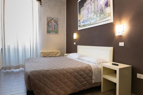 En eller flere senge i et værelse på Hotel Giugiù