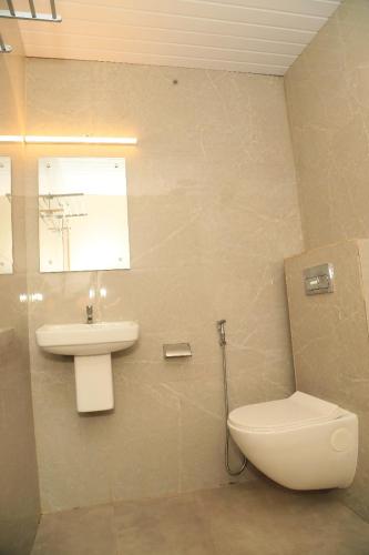 a bathroom with a toilet and a sink at Bekal Eden Resorts in Kāsaragod