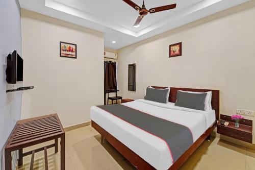a bedroom with a large bed and a ceiling fan at RG SUITES Mount Road in Chennai
