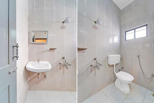 a bathroom with a toilet and a sink at RG SUITES Mount Road in Chennai