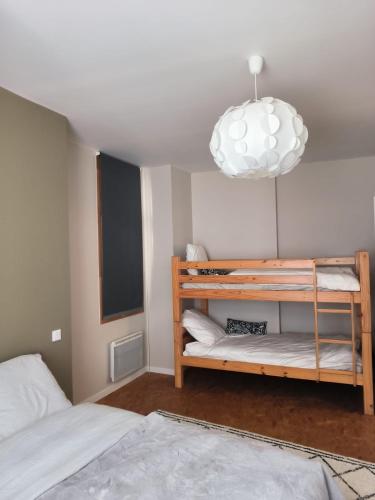 a bedroom with a bunk bed and a pendant light at Furnished T2 apartment in Luchon