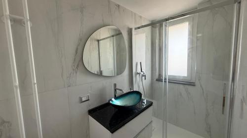 a bathroom with a black sink and a mirror at Laguna Blu in Montepaone Lido