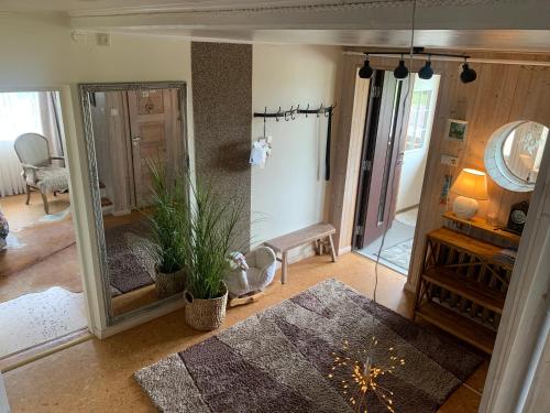 a living room with a large mirror and a plant at Villa Mariett in Kuressaare