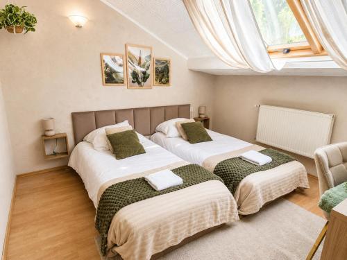a bedroom with two beds in a room at KRK stop near airport in Cholerzyn