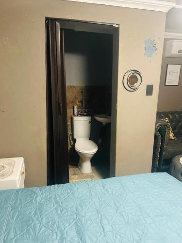 a bathroom with a toilet in a room at Lake boutique hotel empire in Thohoyandou