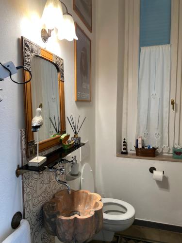 a bathroom with a wooden sink and a toilet at Villa Rosazza in San Salvatore Monferrato