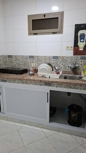 a kitchen counter with an open drawer in a kitchen at Belle apt près de la mer in Tangier